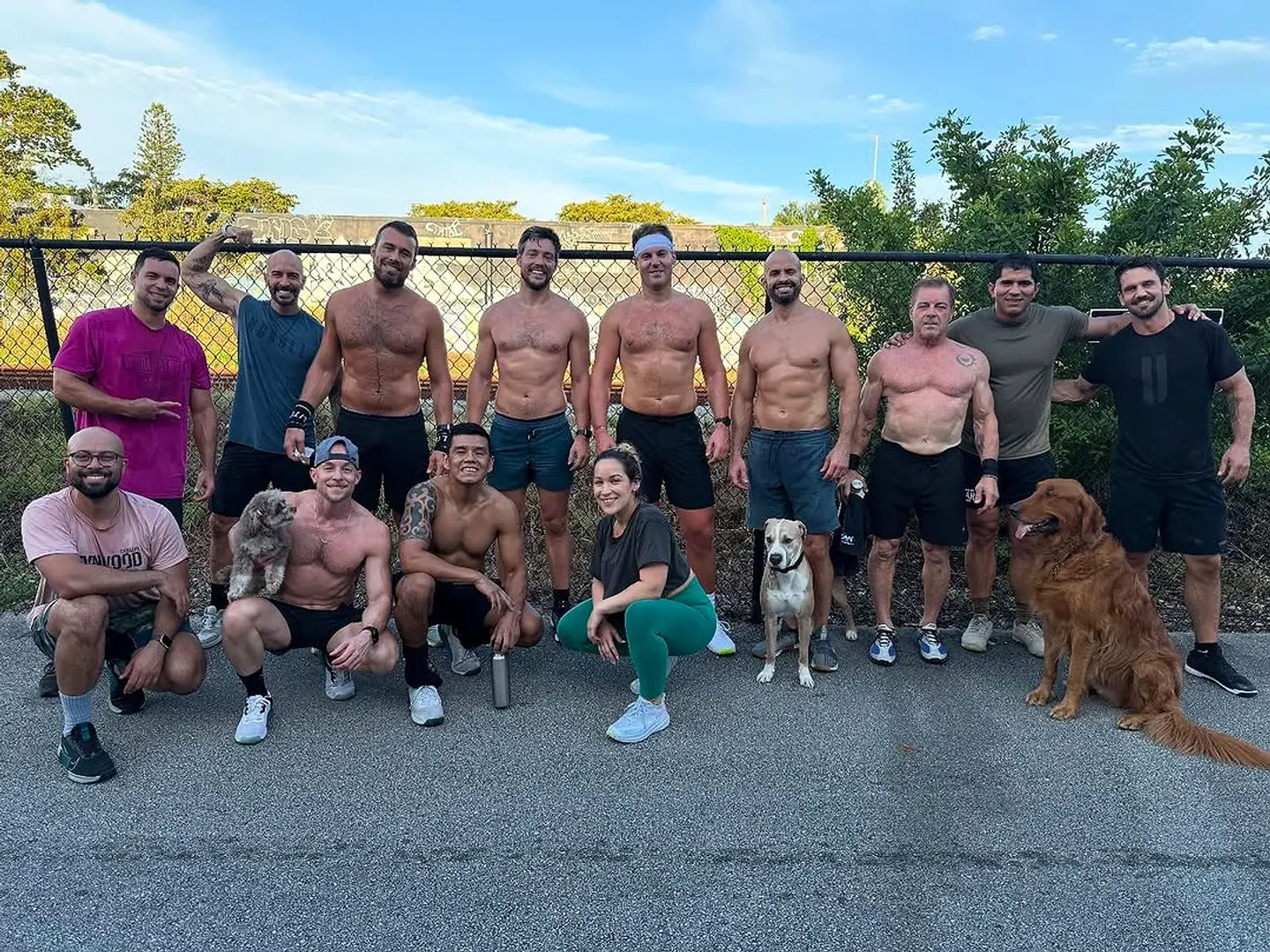 The CrossFit Wynwood crew and the gym dogs posed against the fence outside the box in Little River